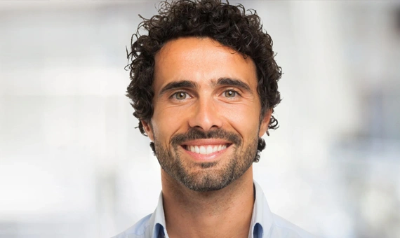 Smiling male patient at Metropolitan Dental Arts, showing confidence and satisfaction after dental treatment.