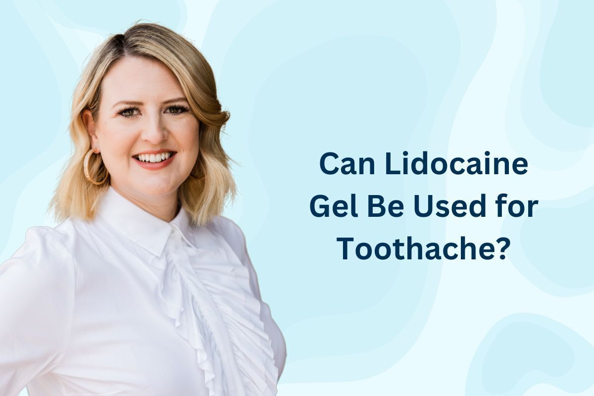 Smiling female dentist in white coat against light blue background for Brooklyn dental practice.
