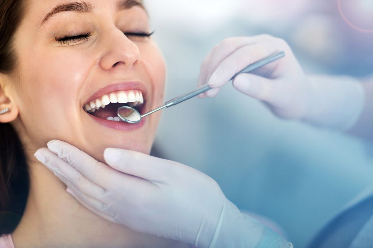 Dentist examining patient's teeth during orthodontic consultation in Brooklyn.