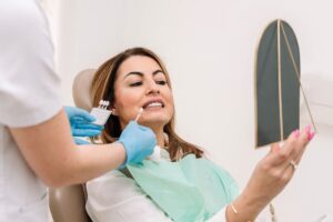 Patient receiving professional teeth whitening treatment at dental office in Brooklyn.