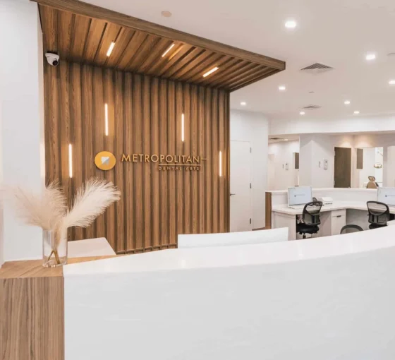 Modern dental office reception area with wood-paneled walls and front desk