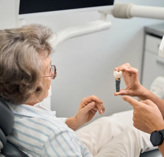 Dentist using a digital device to guide a patient during dental treatment