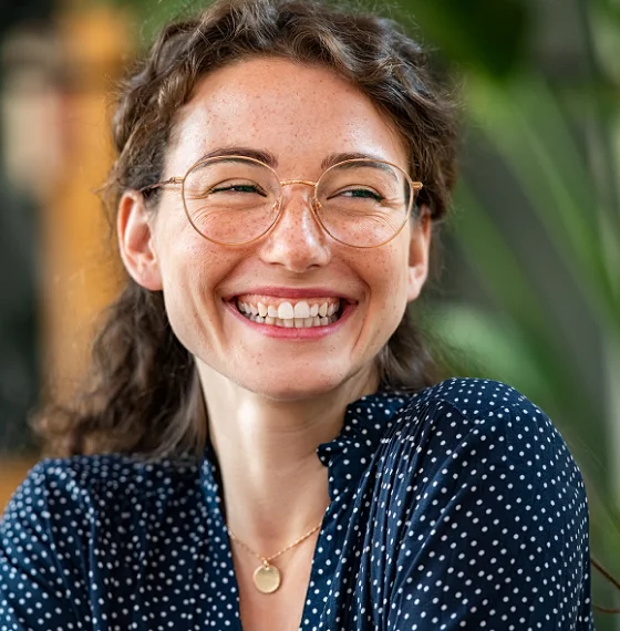 Smiling woman wearing glasses and a blue sweater