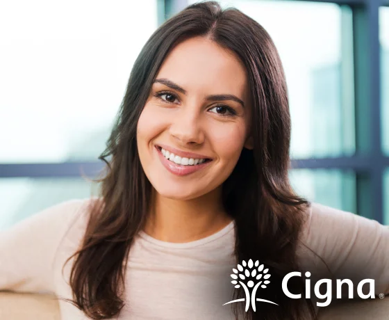 Woman smiling with Cigna dental insurance branding