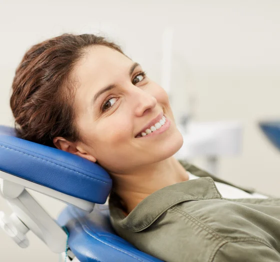 Woman reclining in a dental chair during a dental examination