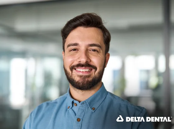 Man smiling with Delta Dental insurance branding