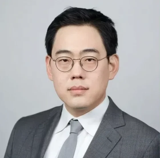 Professional headshot of a male dental professional wearing glasses