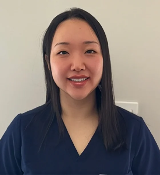 Professional headshot of a female dental professional with long dark hair