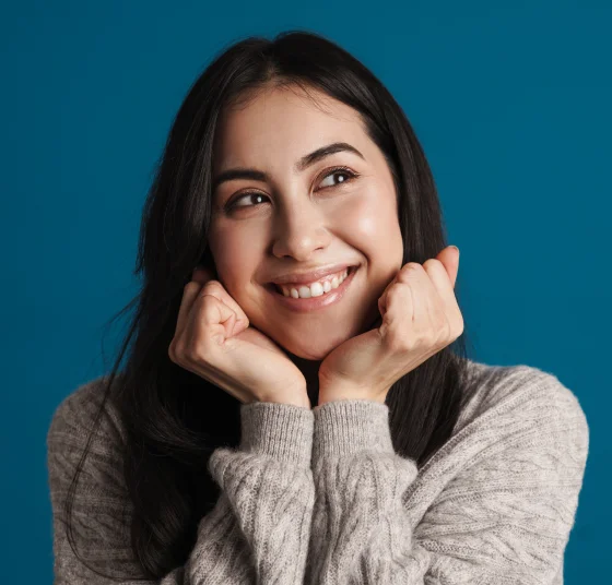 Smiling woman with her hands resting under her chin