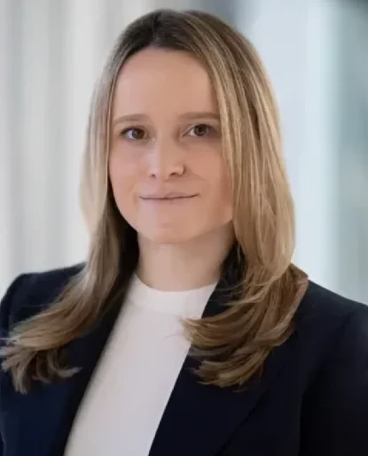 Professional headshot of a woman wearing a black blazer and white shirt