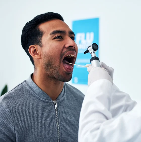 Man smiling while receiving dental treatment from a dental professional