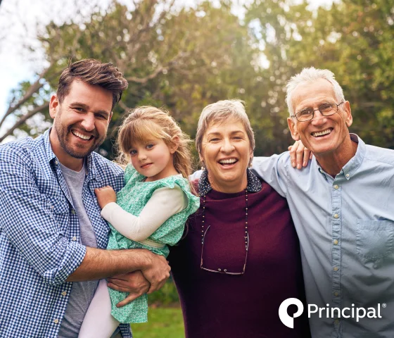 Older couple smiling together with Principal dental insurance branding