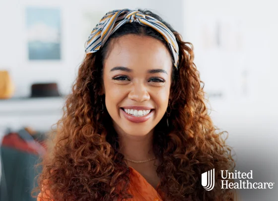 Smiling woman with UnitedHealthcare dental insurance branding