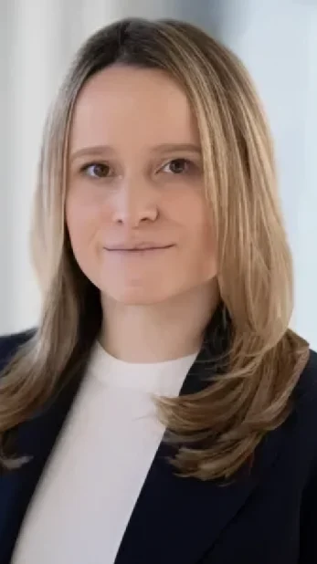 Professional headshot of a woman wearing a black blazer and white shirt