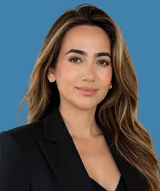Professional headshot of a female dental professional with long dark hair