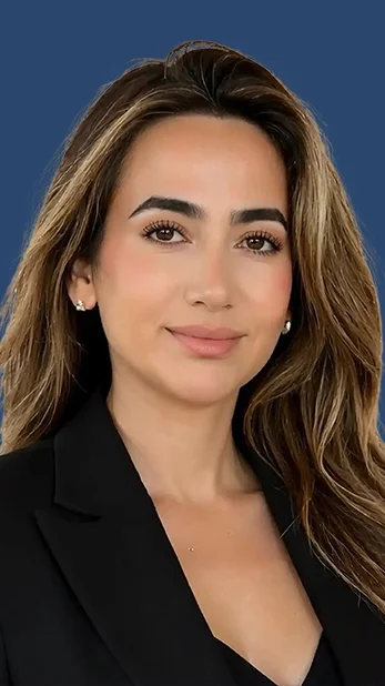 Professional headshot of a woman with long hair wearing a black top